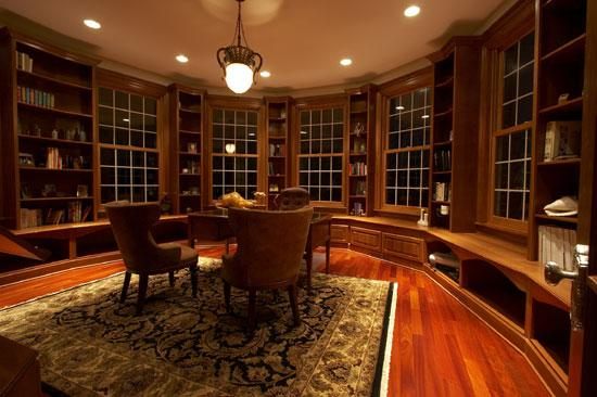 Zaxx built-in library bookcases around curved windows